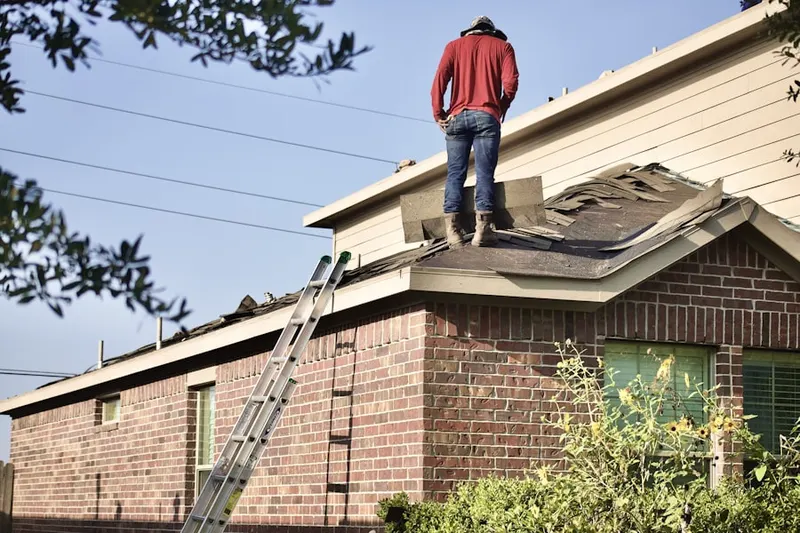 Professional roofer working on a residential roof in Pine Mountain